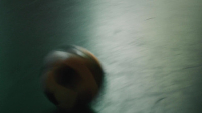 a blurry photo of a person's hand holding a doughnut