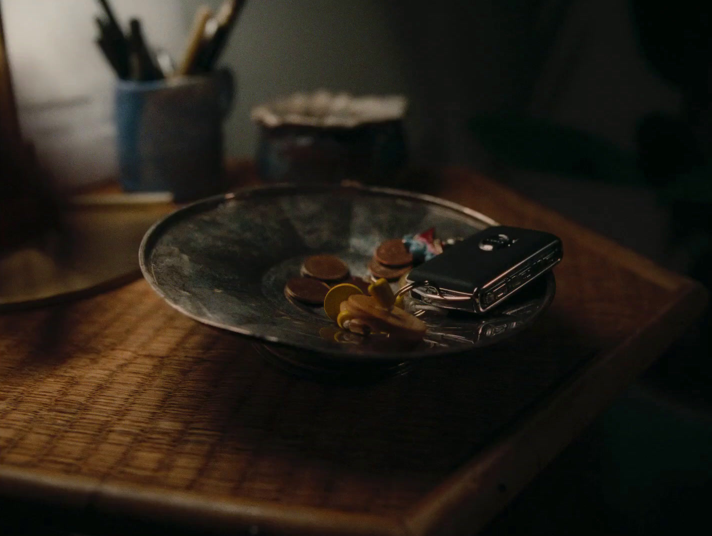 a cell phone sitting on top of a metal bowl