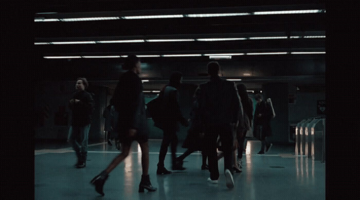 a group of people walking down a hallway