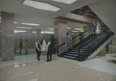 a group of people standing in front of a staircase