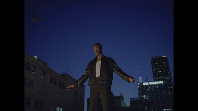 a man standing in the middle of a city at night