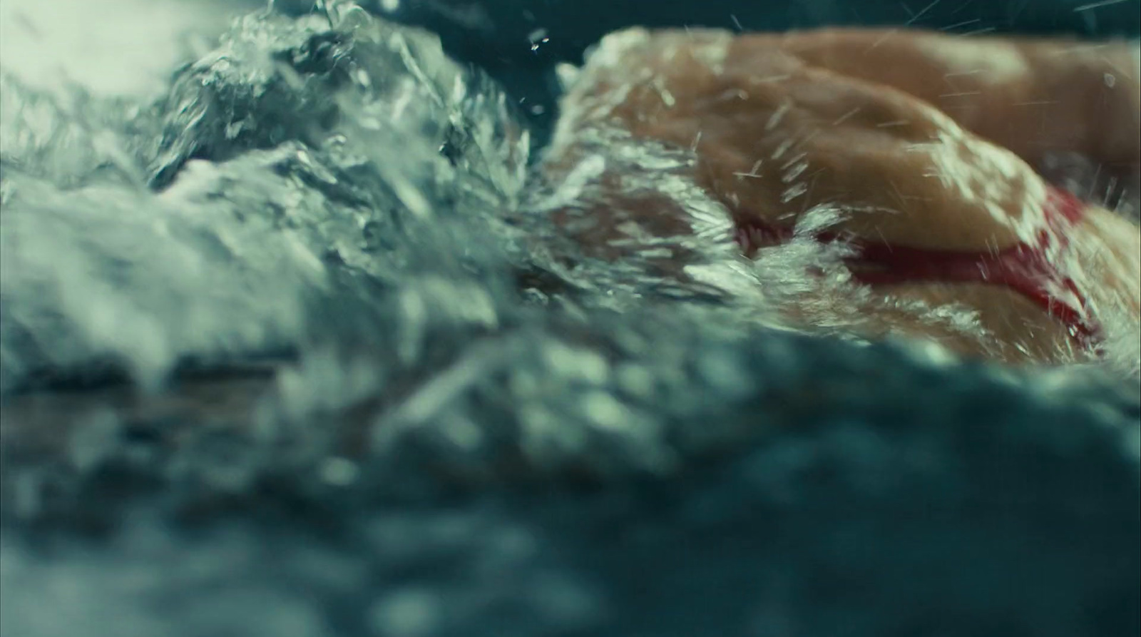 a close up of a person swimming in a body of water