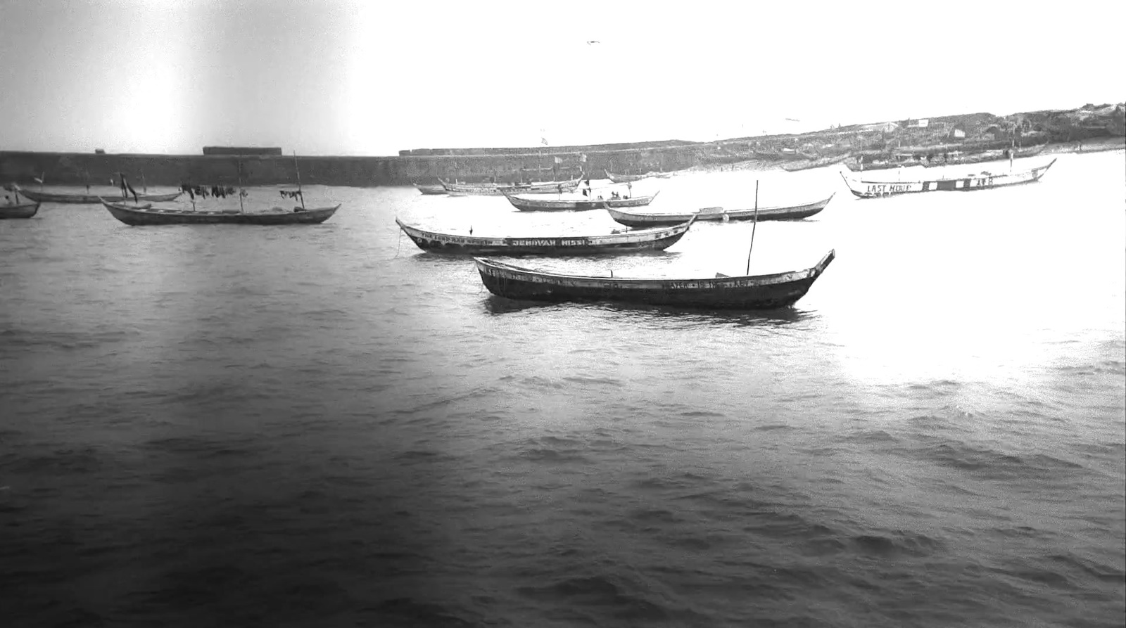 a group of boats floating on top of a body of water