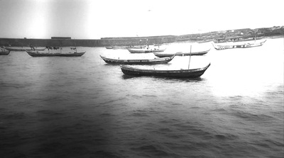 a group of boats floating on top of a body of water