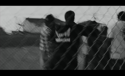 a group of men standing next to each other behind a fence