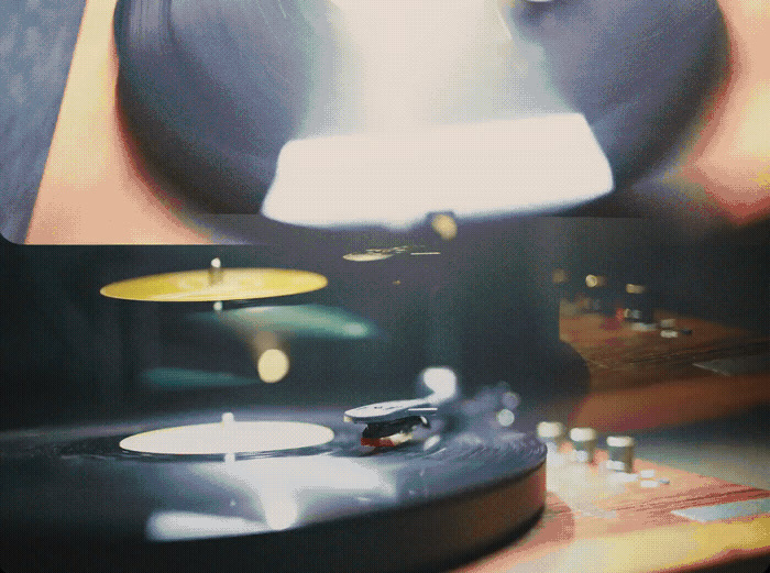 a close up of a record player with a blurry background