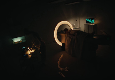 a person laying on a bed in a dark room