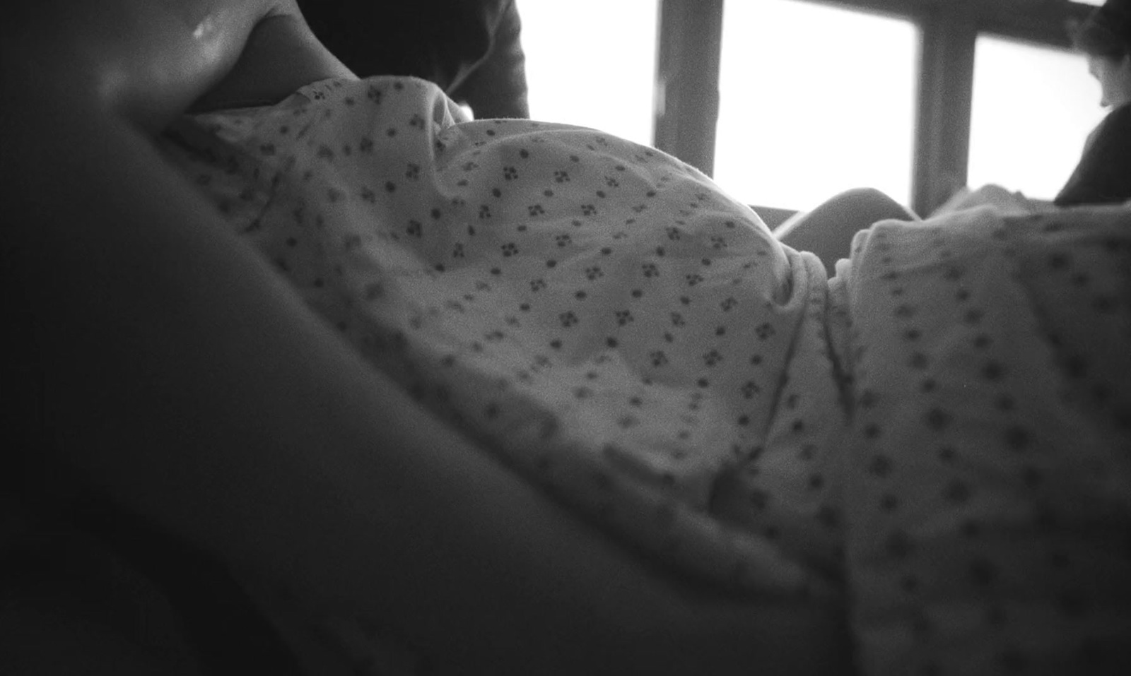 a black and white photo of a baby in a crib