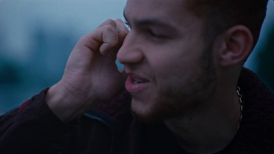 a man talking on a cell phone with his eyes closed