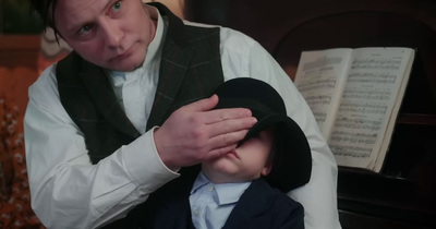 a man is holding a small child in his lap