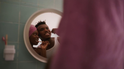 a man brushing his teeth in front of a mirror