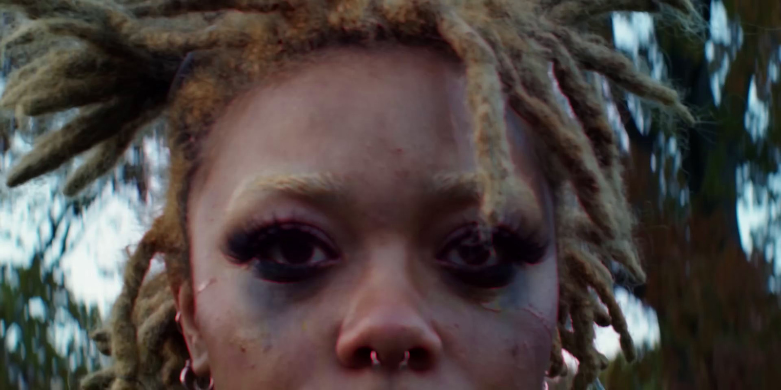 a close up of a person with dreadlocks