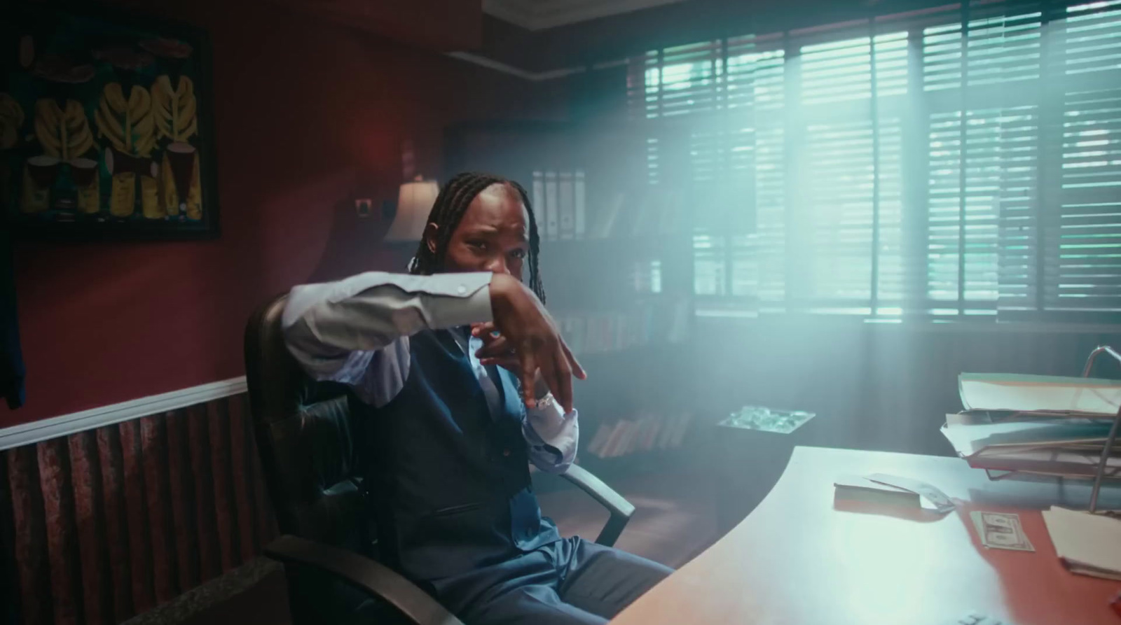 a man in a suit sitting at a desk