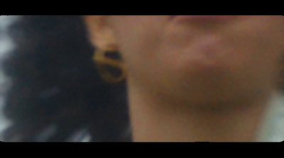 a close up of a woman's face with ear rings