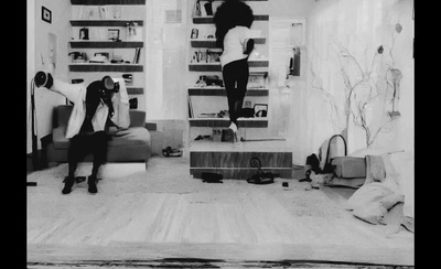 a black and white photo of two women in a living room