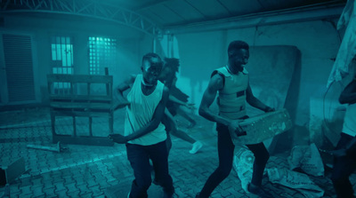 a group of young men dancing in a dark room