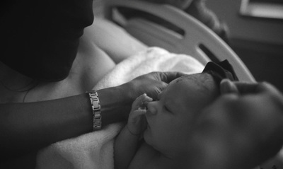 a woman holding a baby in her arms