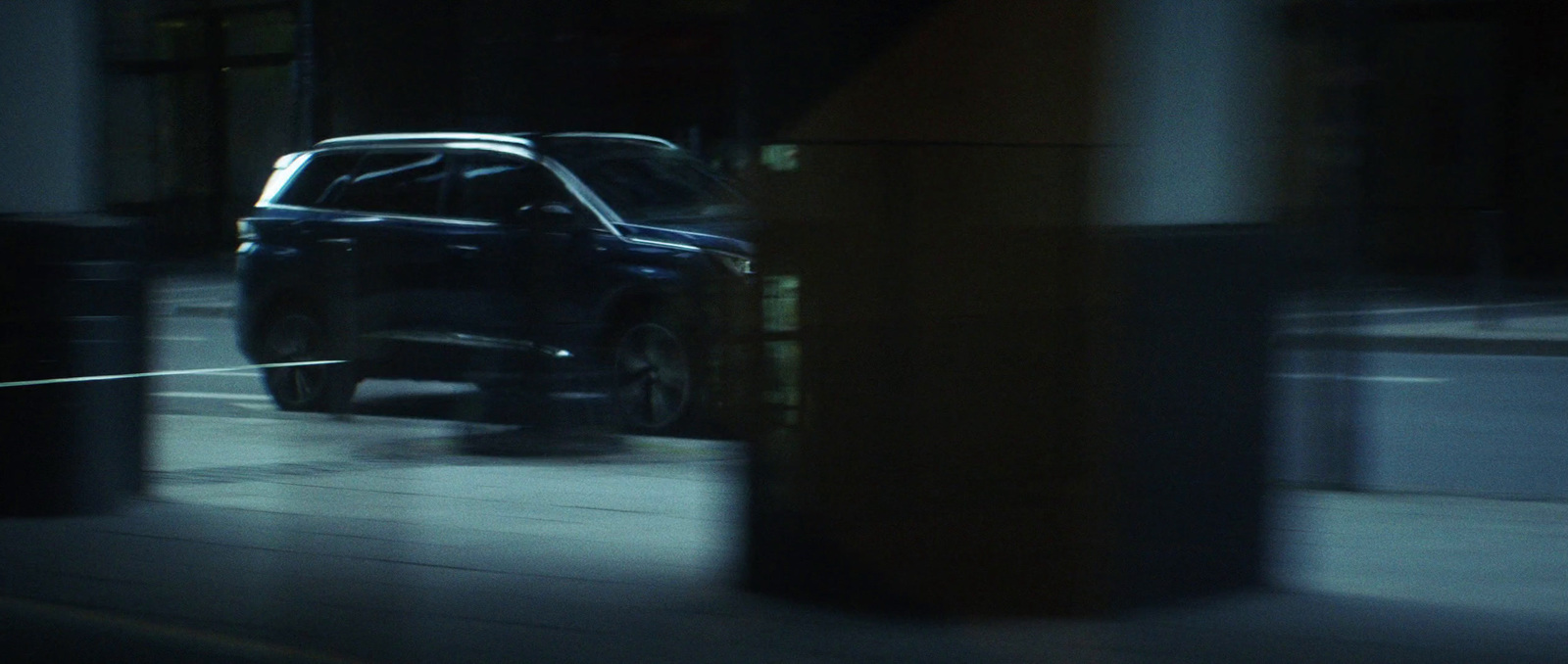 a car driving down a city street at night