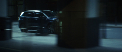 a car driving down a city street at night