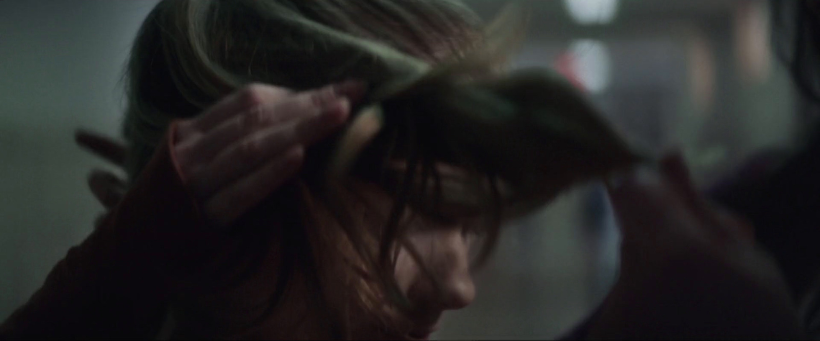 a woman is blow drying her hair in the mirror