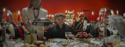 a man sitting at a table in front of a plate of food