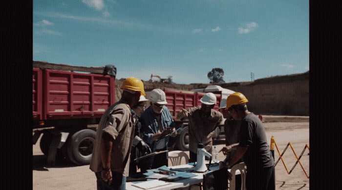 a group of men standing around a table