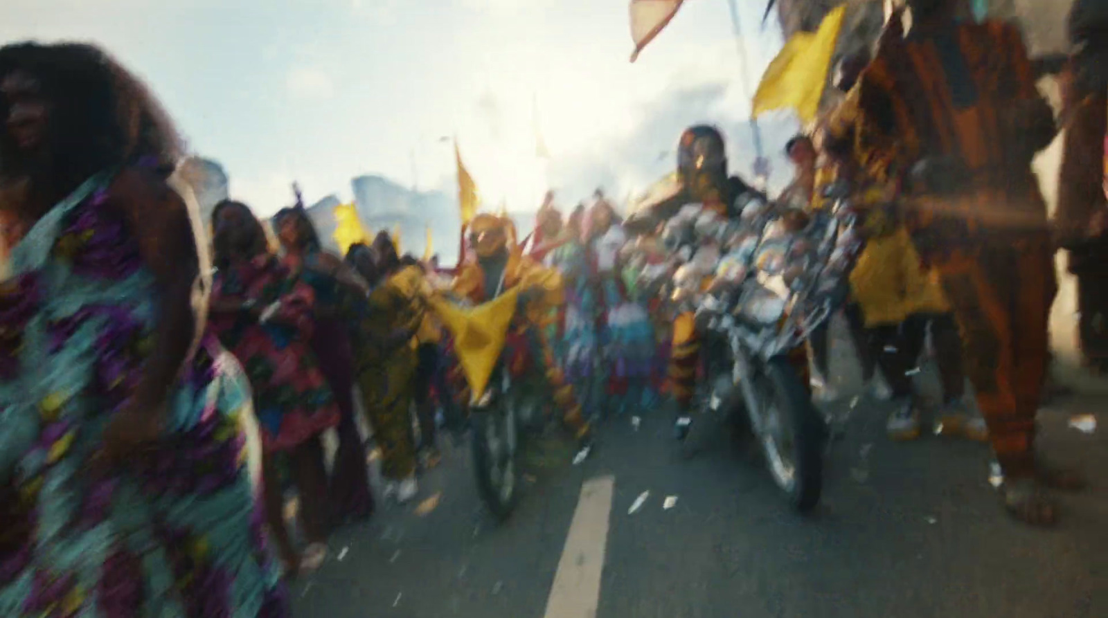 a group of people riding motorcycles down a street