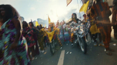 a group of people riding motorcycles down a street