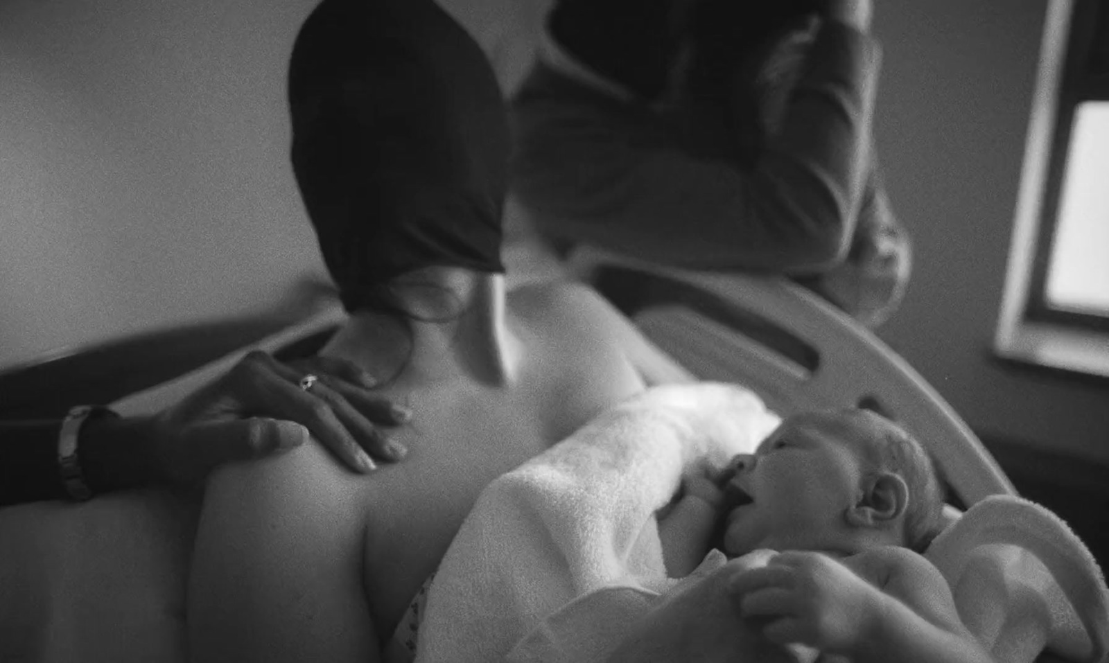 a black and white photo of a baby in a crib