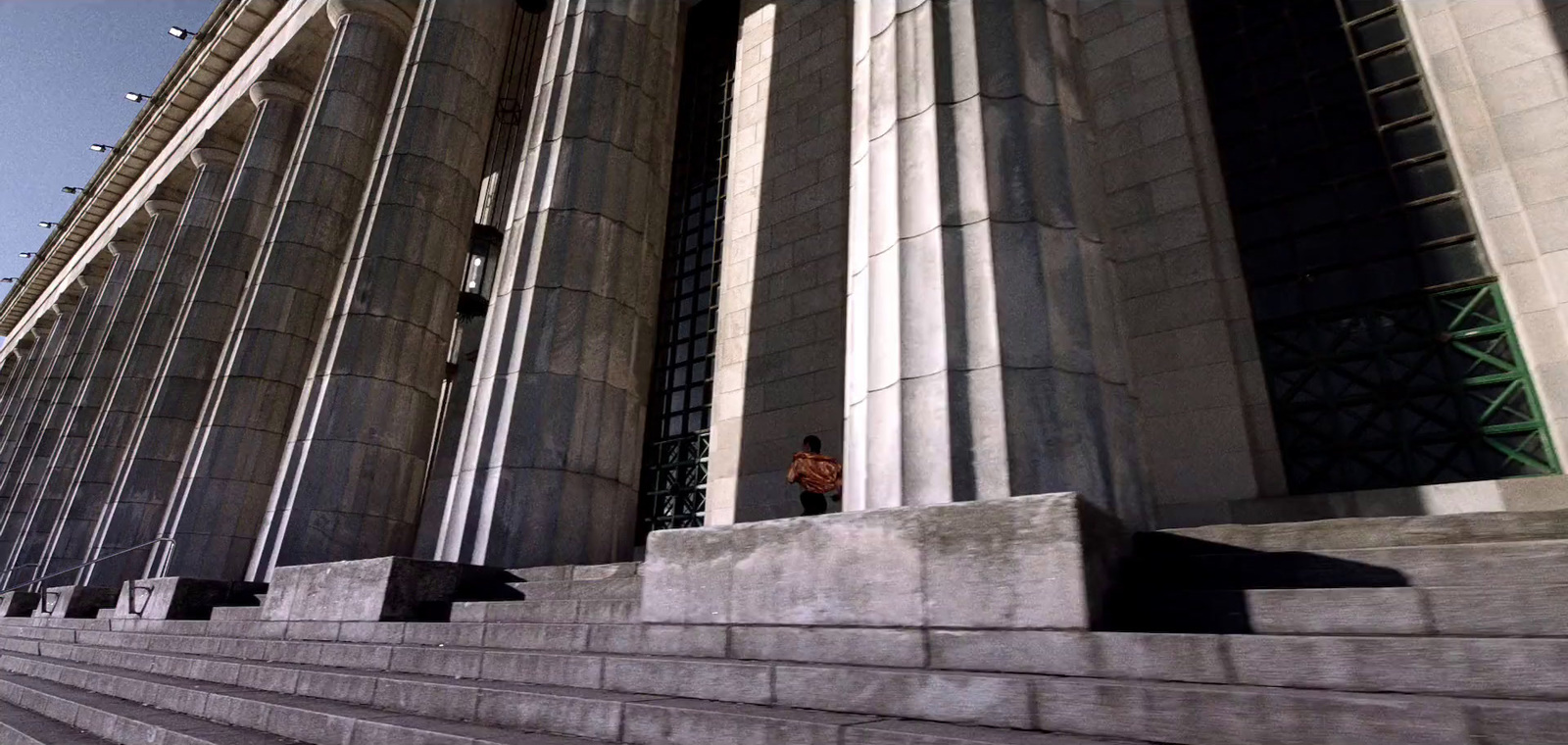 a man riding a skateboard down the side of a set of stairs