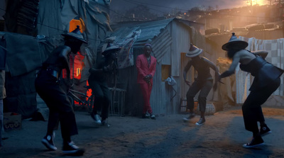 a group of people dancing in the street at night