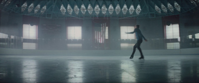 a woman is walking through a building in the fog