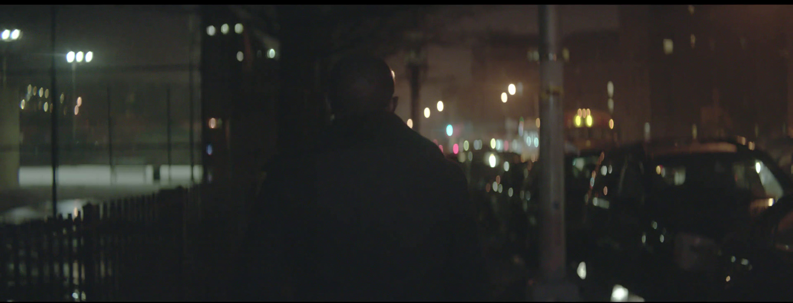 a man standing in front of a window at night