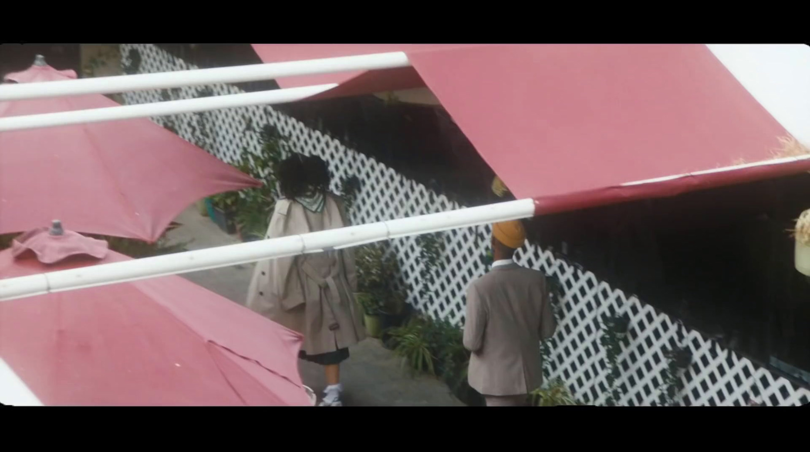 a couple of people walking down a street with umbrellas