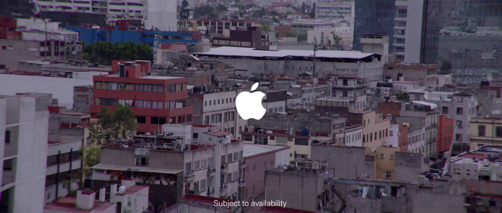 an aerial view of a city with buildings and an apple logo