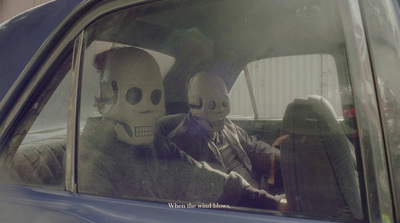 a couple of people sitting in the back seat of a car