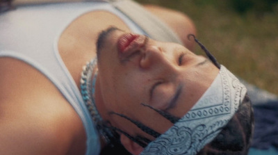 a woman laying on top of a blue blanket