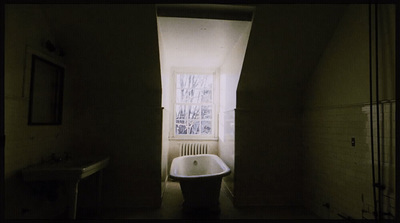 a bath tub sitting in a bathroom next to a window