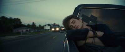 a man sleeping in the back of a pickup truck