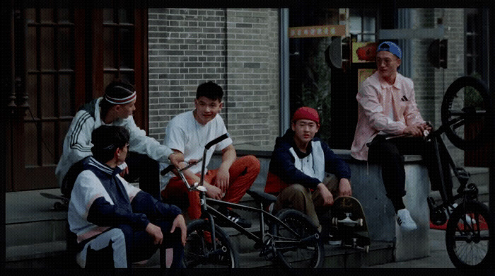 a group of young men sitting on the steps of a building