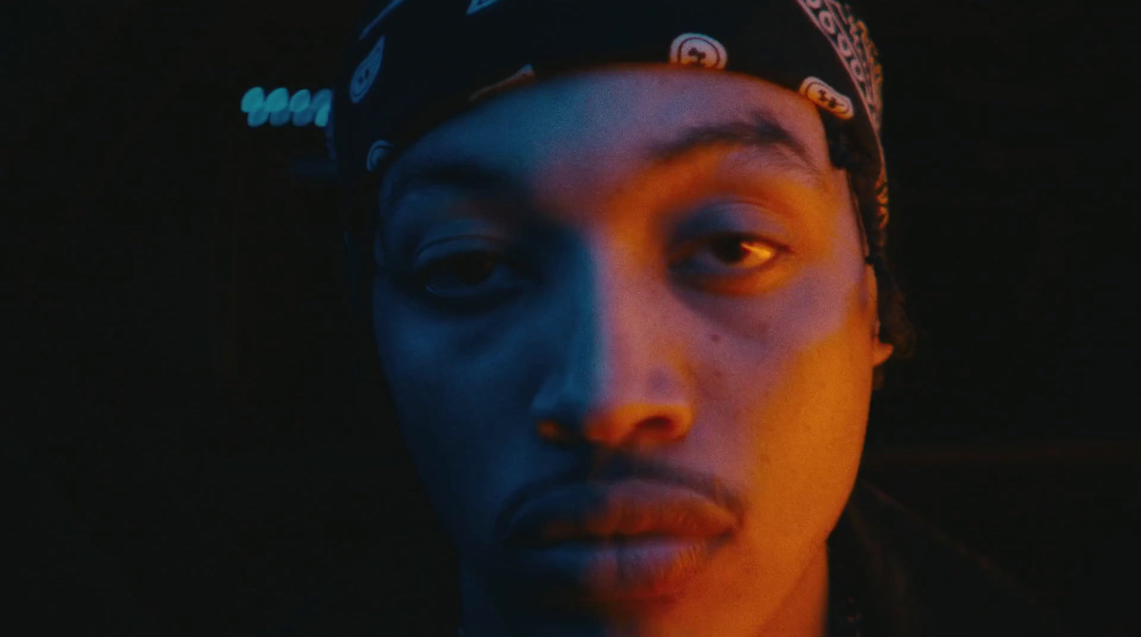 a close up of a person wearing a bandana