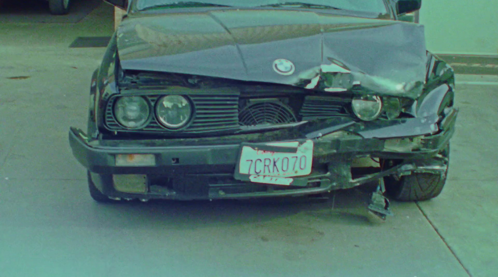 a car that has been smashed in half on the side of the road