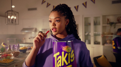 a woman in a purple shirt is holding a can of food