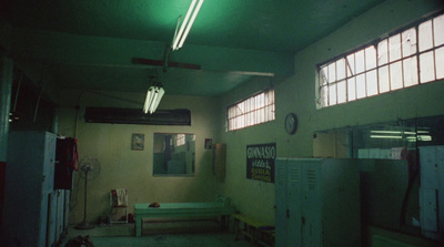 a dimly lit room with a green light