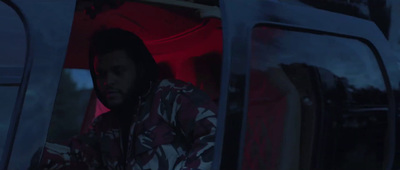 a man sitting in the back of a bus at night