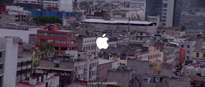 an apple logo on a building in a city