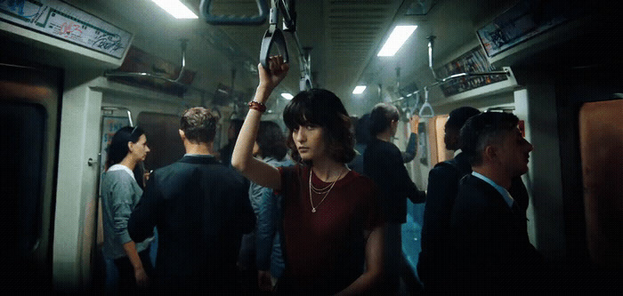 a group of people standing on a subway car