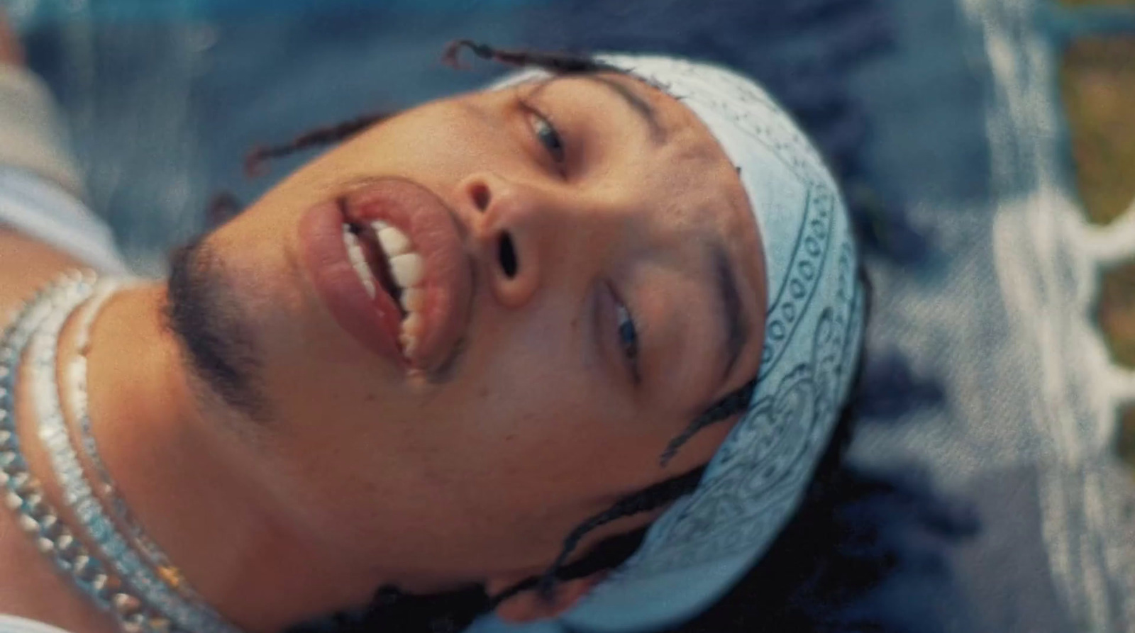 a close up of a person wearing a bandana