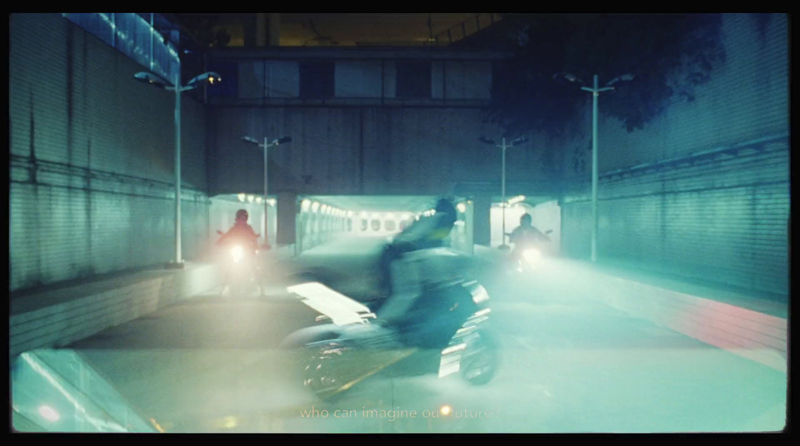 a man riding a motorcycle through a tunnel