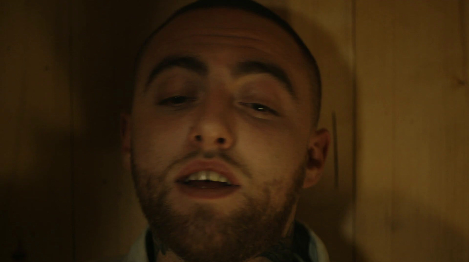 a man with his eyes closed in a dark room